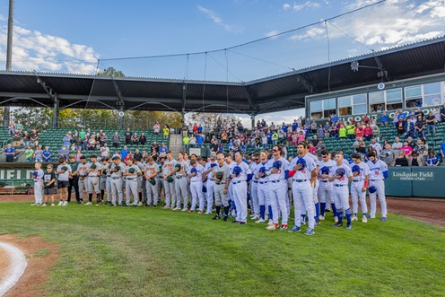 Ogden and Boise players stand behind homeplate during National Anthem in ogden UT